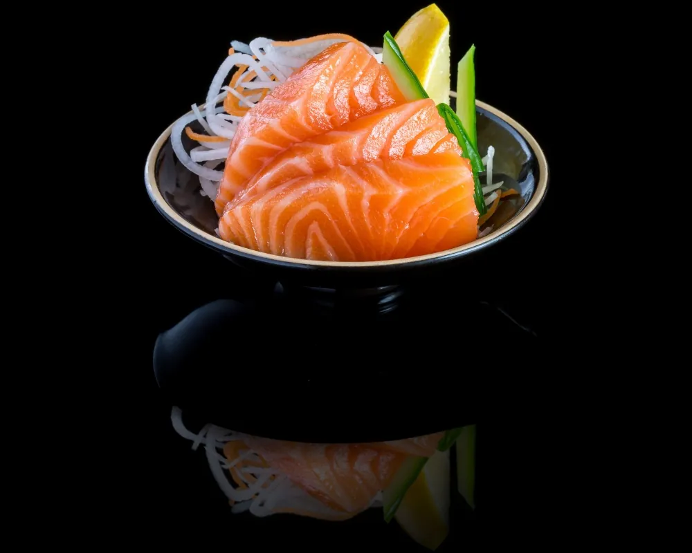 Fresh salmon sashimi over daikon radish at Nova Sushi & Teriyaki, a Japanese Restaurant in Jackson Heights